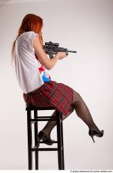 Woman Adult Average White Fighting with gun Sitting poses Casual